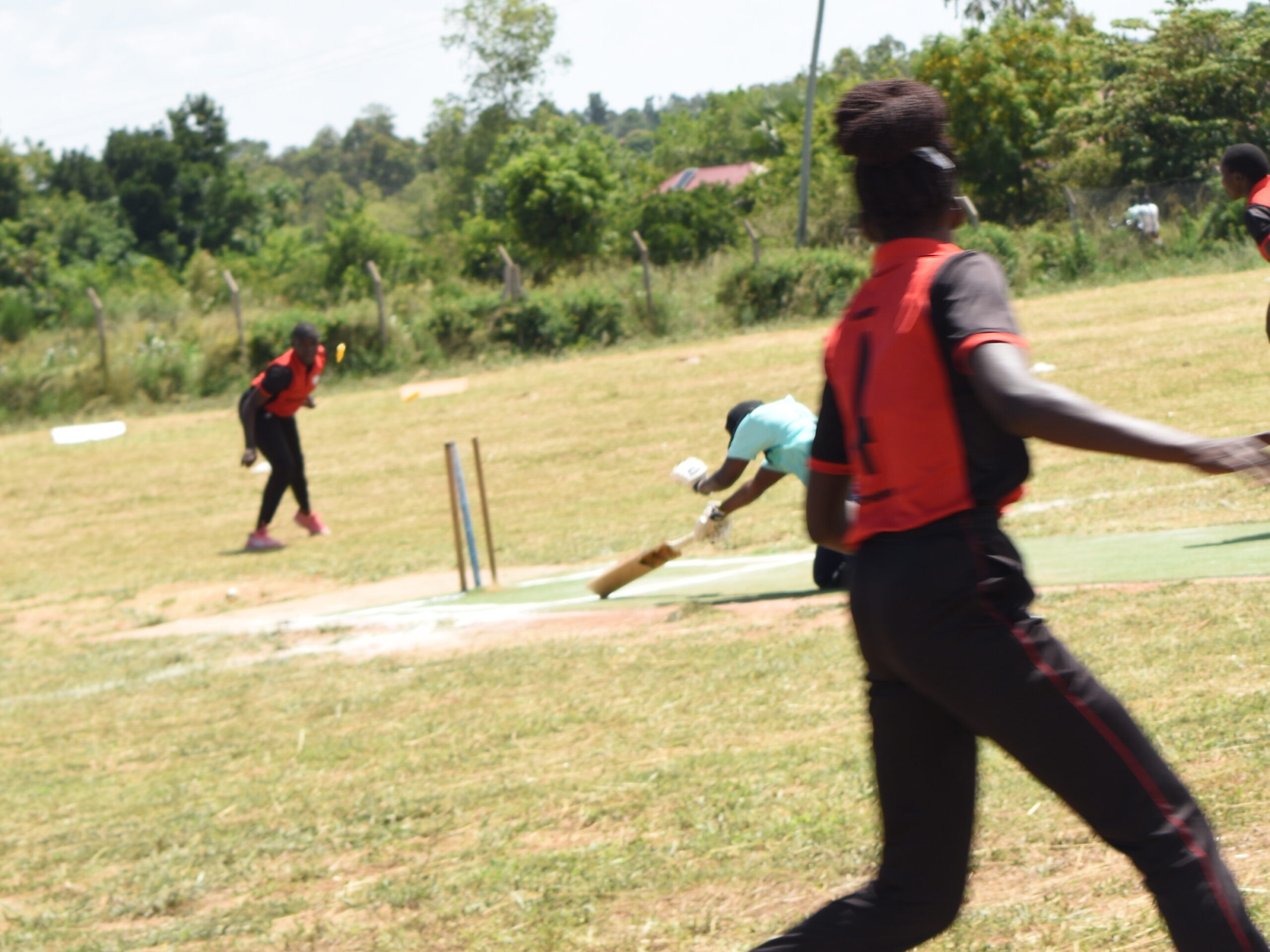 Cricket ground with players practicing