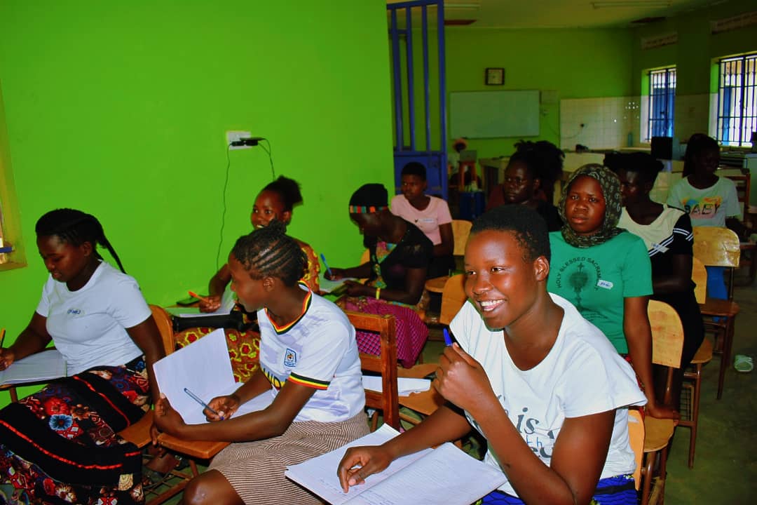 Students studying with cricket equipment nearby